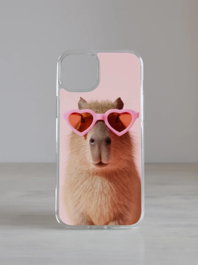 Kapibaaraga roosal taustal roosades südameprillides – lõbus ja trendikas iPhone telefoniümbris.